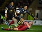 Ken Pisi of Northampton crashes over the tryline to score the opening try despite the tackle from Hadleigh Parkes of Scarlets during the European Rugby Champions Cup Pool 3 match between Northampton Saints and Scarlets at Franklin's Gardens on November 14