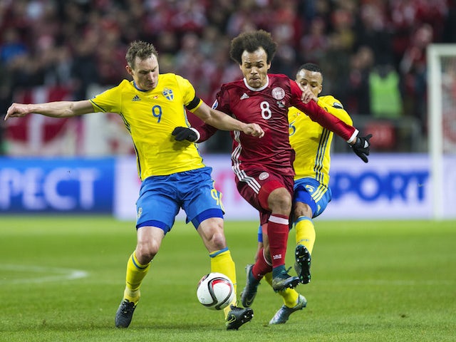 Sweden 9 Kim Kallstrom and Sweden 5 Martin Olsson against Denmark 8 Martin C. Braithwaite during a European Qualifier Play-Off between Sweden and Denmark on November 14, 2015 in Solna, Sweden.