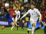 Spain's forward Mario (L) scores past England's defender Chris Smalling (C) and Spain's forward Paco Alcacer during the friendly football match Spain vs England at the Jose Rico Perez stadium in Alicante on November 13, 2015.