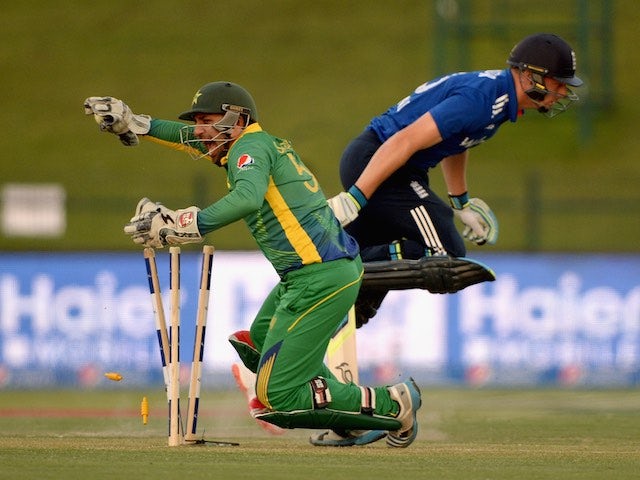 Sarfraz Ahmed of Pakistan runs out England's Jos Buttler during the first one-day international in Abu Dhabi on November 11, 2015