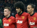 Jones, Felliani and Ferdinand line up for a photograph before the start of the UEFA Champions League quarter-final first leg football match between Manchester United and Bayern Munich at Old Trafford in Manchester on April 1, 2014.