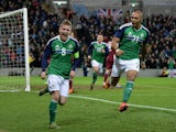 Steve Davis (L) of Northern Ireland celebrates after scoring during the international football friendly match between Northern Ireland and Latvia at Windsor Park on November 13, 2015 in Belfast, Northern Ireland.