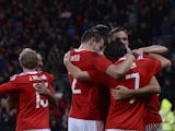 Wales players celebrate the goal scored by Wales's midfielder Joe Ledley to equalise 1-1 during the international friendly football match between Wales and Netherlands at Cardiff City Stadium in south Wales on November 13, 2015.