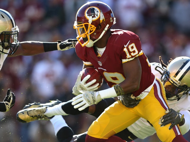 Rashad Ross #19 of the Washington Redskins returns a kick-off as his tackled by defensive back Brian Dixon #20 of the New Orleans Saints in the first quarter at FedExField on November 15, 2015