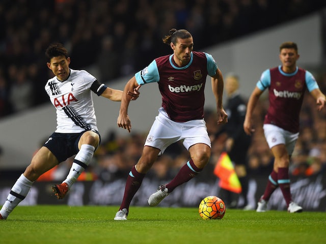 Andy Carroll of West Ham United is challenged by Heung-Min Son of Tottenham Hotspur during the Barclays Premier League match between Tottenham Hotspur and West Ham United at White Hart Lane on November 22, 2015 in London, England.