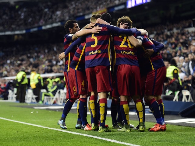 Barcelona's players celebrate a goal during the Spanish league 'Clasico' football match Real Madrid CF vs FC Barcelona at the Santiago Bernabeu stadium in Madrid on November 21, 2015.