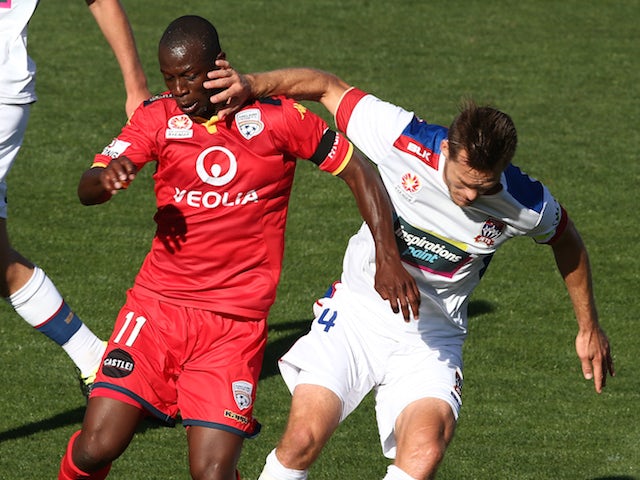 Bruce Djite of Adelaide United competes with Nigel Boogaard of Newcastle Jets during the round seven A-League match between Adelaide United and the Newcastle Jets at Coopers Stadium on November 22, 2015 in Adelaide, Australia.