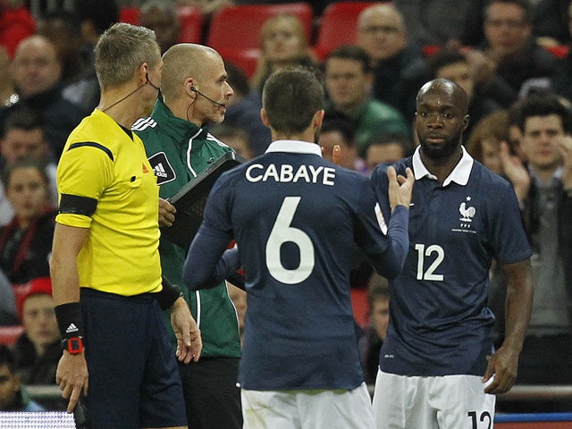 France's midfielder Lassana Diarra (R) comes on to replace France's midfielder Yohan Cabaye (C) during the friendly football match between England and France at Wembley Stadium in west London on November 17, 2015
