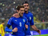 Italy's midfielder Claudio Marchisio (L) celebrates with Italy's forward Graziano Pelle (R) after scoring a penalty during the friendly football match between Italy and Romania, on November 17, 2015