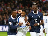 Jesse Lingard of England is greeted by Patrice Evra and Paul Pogba of France prior to the International Friendly match between England and France at Wembley Stadium on November 17, 2015