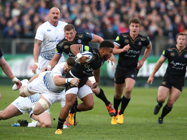 Kyle Eastmond of Bath is tackled by Jamie Heaslip during the European Rugby Champions Cup match between Bath and Leinster at the Recreation Ground on November 21, 2015