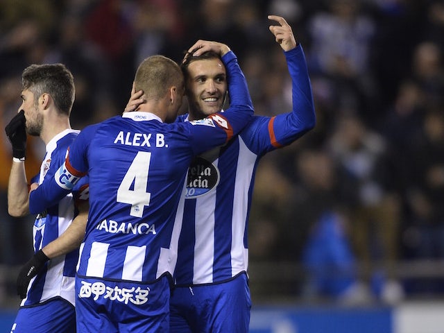 Deportivo La Coruna's midfielder Lucas Perez (R) hugs his teammate midfielder Alex Bergantinos after scoring their second goal during the Spanish league football match RC Deportivo La Coruna vs Celta Vigo at the Municipal de Riazor stadium in La Coruna on