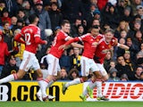 Bastian Schweinsteiger of Manchester United celebrates his team's second goal scored by Troy Deeney of Watford with his team mates during the Barclays Premier League match between Watford and Manchester United at Vicarage Road on November 21, 2015