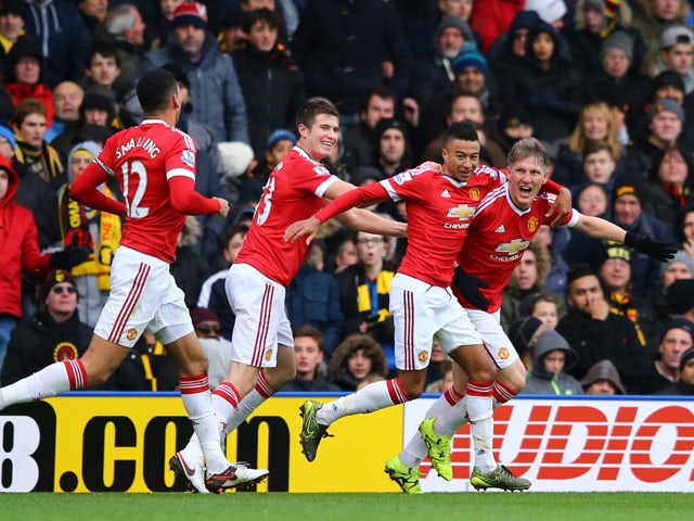 Bastian Schweinsteiger of Manchester United celebrates his team's second goal scored by Troy Deeney of Watford with his team mates during the Barclays Premier League match between Watford and Manchester United at Vicarage Road on November 21, 2015