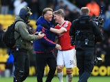 Manager Louis van Gaal (2nd L) and Bastian Schweinsteiger (2nd R) of Manchester United celebrate their 2-1 win in the Barclays Premier League match between Watford and Manchester United at Vicarage Road on November 21, 2015