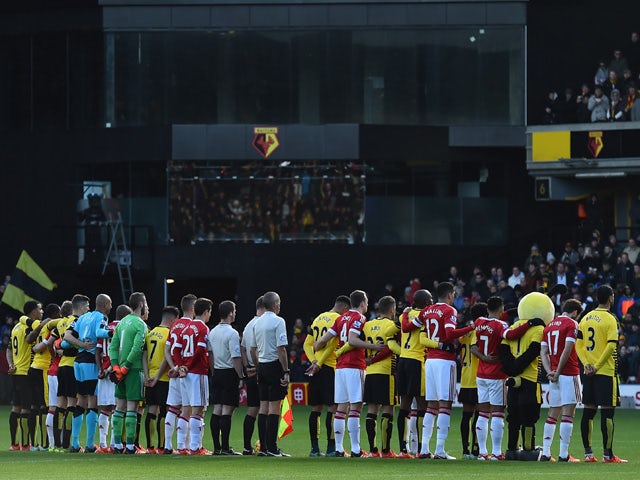Officials, and players from both sides join together as 'La Marseillaise' is played for the victims of the Paris terrorist attacks ahead of the English Premier League football match between Watford and Manchester United at Vicarage Road Stadium in Watford