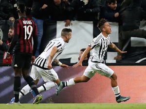 Juventus' forward Argentinian Paulo Dybala (R) celebrates with teammates after scoring a goal during the Italian Serie A football match between Juventus and AC Milan on November 21, 2015 at the Juventus Stadium in Turin.