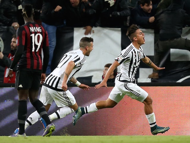 Juventus' forward Argentinian Paulo Dybala (R) celebrates with teammates after scoring a goal during the Italian Serie A football match between Juventus and AC Milan on November 21, 2015 at the Juventus Stadium in Turin.