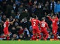Roberto Firmino (1st R) of Liverpool celebrates scoring his team's third goal with his team mates during the Barclays Premier League match between Manchester City and Liverpool at Etihad Stadium on November 21, 2015 in Manchester, England.