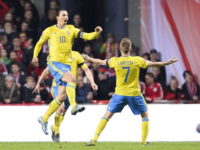 Sweden's forward and team captain Zlatan Ibrahimovic (L) celebartes after scoring a goal during the Euro 2016 second leg play-off football match between Denmark and Sweden at Parken stadium in Copenhagen on November 17, 2015