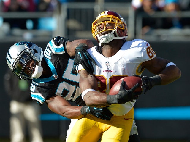 Bene' Benwikere #25 of the Carolina Panthers defends a pass to Pierre Garcon #88 of the Washington Redskins during their game at Bank of America Stadium on November 22, 2015