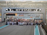 F1 personnel, teams and media mill around on the starting grid before the start of the Abu Dhabi Formula One Grand Prix at the Yas Marina circuit on November 29, 2015.