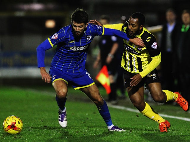 George Francomb of AFC Wimbledon and Ashley Hemmings of Dagenham and Redbridge challenge for the ball during the Sky Bet League Two match between AFC Wimbledon and Dagenham and Redbridge at The Cherry Red Records Stadium on November 24, 2015