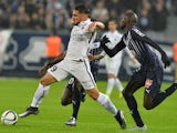 Caen's French forward Andy Delort (L) vies with Bordeaux's French defender Cedric Yambere during the French L1 football match between Bordeaux and Caen on November 29, 2015 at the Matmut Atlantique stadium in Bordeaux, southwestern France. 