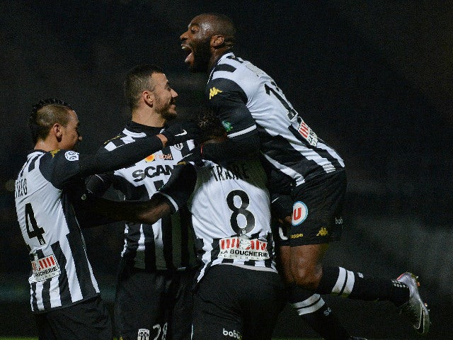 Angers' French forward Gilles Sunu (R) celebrates with teammates after scoring a goal during the French L1 football match between Angers and Lille at the Jean Bouin Stadium in Angers, western France, on November 28, 2015.