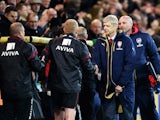 Arsene Wenger manager of Arsenal shakes hands with the Norwich City team bench after the Barclays Premier League match between Norwich City and Arsenal at Carrow Road on November 29, 2015