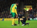 Lewis Grabban of Norwich City stands over an injured Laurent Koscielny of Arsenal during the Barclays Premier League match between Norwich City and Arsenal at Carrow Road on November 29, 2015
