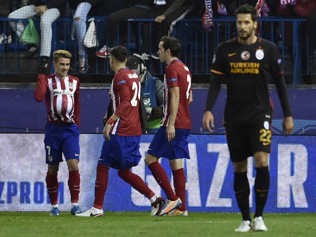 Atletico Madrid's French forward Antoine Griezmann (L) celebrates a goal with teammates during the UEFA Champions League Group C football match Club Atletico de Madrid vs Galatasaray AS at the Vicente Calderon stadium in Madrid on November 25, 2015