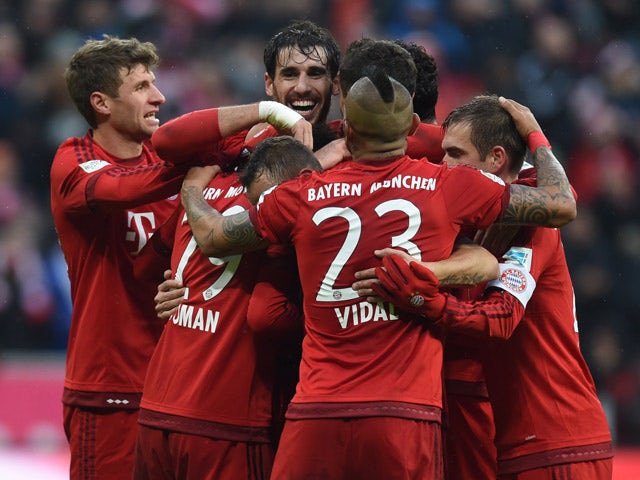 Bayern Munich players celebrate after the second goal during the German first division Bundesliga football match FC Bayern Munich vs Hertha Berlin in Munich, southern Germany, on November 28, 2015