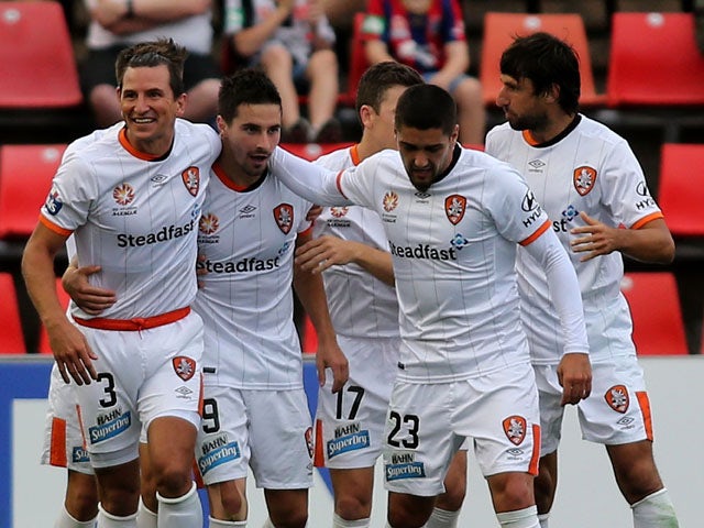 Brisbane Roar players celebrate a goal during the round eight A-League match between the Newcastle Jets and Brisbane Roar at Hunter Stadium on November 28, 2015