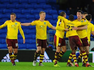 The Burnley team celebrate as Matthew Connolly of Cardiff City (not pictured) scores an own goal during the Sky Bet Championship match between Cardiff City and Burnley at the Cardiff City Stadium on November 28, 2015