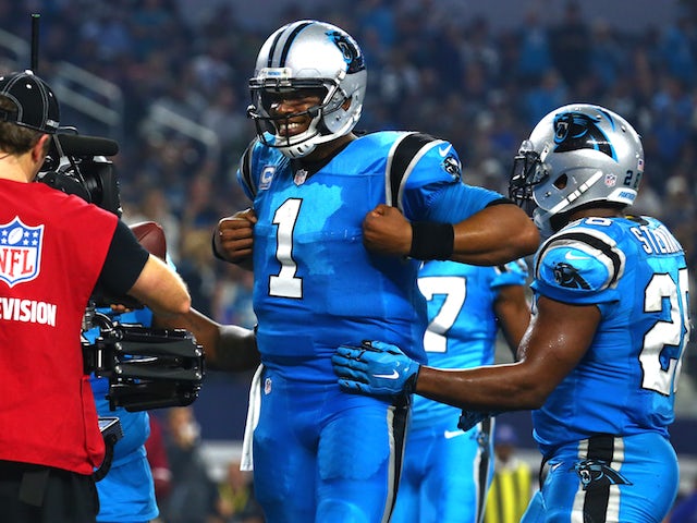 Cam Newton #1 of the Carolina Panthers celebrates with teammate Jonathan Stewart #28 after Newton scored a touchdown against the Dallas Cowboys in the second half at AT&T Stadium on November 26, 2015 in Arlington, Texas.