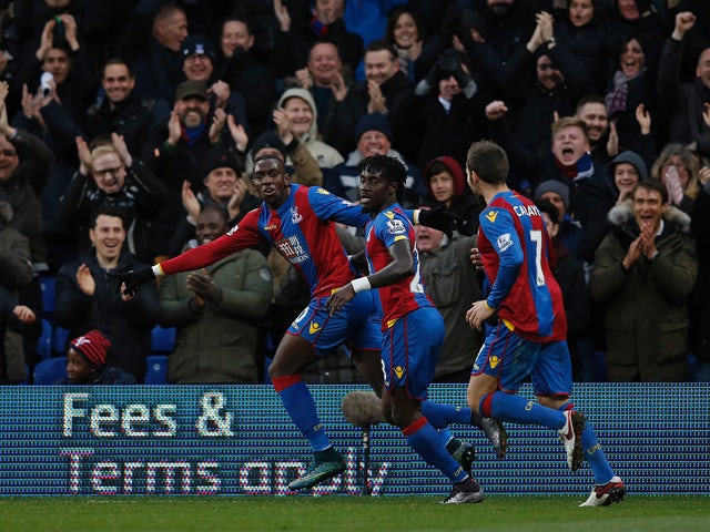Crystal Palace's French-born Congolese midfielder Yannick Bolasie (L), celebrates with Crystal Palace's Senegalese defender Pape Souare (C) and Crystal Palace's French midfielder Yohan Cabaye after scoring his team's second goal during the English Premier