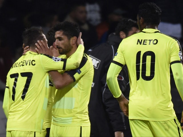 Gent's Serbian midfielder Danijel Milicevic (L) celebrates with teammates after scoring a goal during the UEFA Champions League group H football match between Lyon and Gent on November 24, 2015
