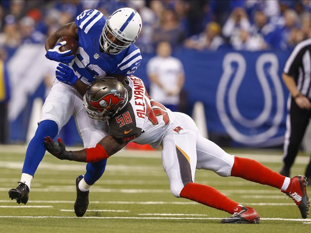 Frank Gore #23 of the Indianapolis Colts is tackled by Kwon Alexander #58 of the Tampa Bay Buccaneers at Lucas Oil Stadium on November 29, 2015