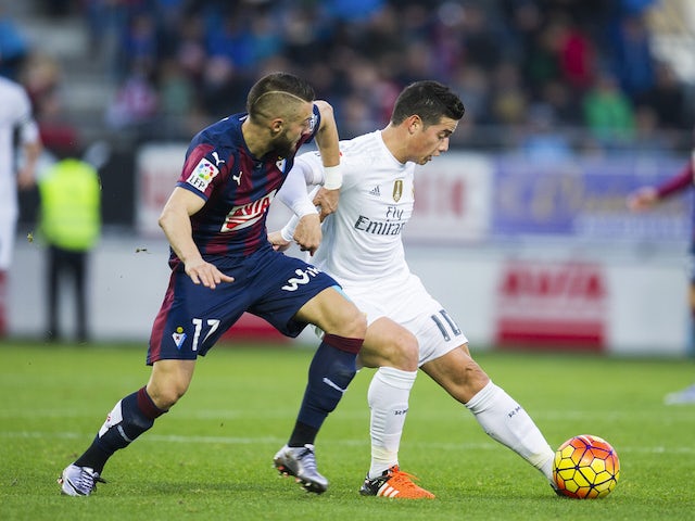 James Rodriguez of Real Madrid duels for the ball with David Junca of SD Eibar during the La Liga match between SD Eibar and Real Madrid at Ipurua Municipal Stadium on November 29, 2015 in Eibar, Spain.