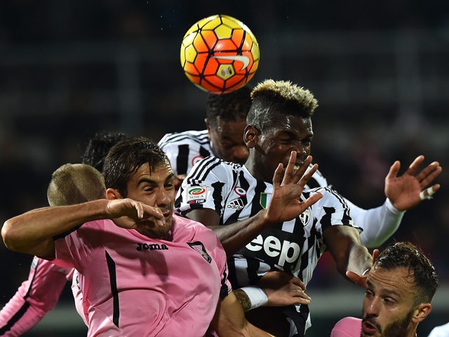 Juventus' midfielder from France Paul Pogba (Top R) heads the ball in front of Palermo's midfielder from Croatia Mato Jajalo (L) and Palermo's forward from Italy Alberto Gilardino (R) during the Italian Serie A football match between Palermo and Juventus 
