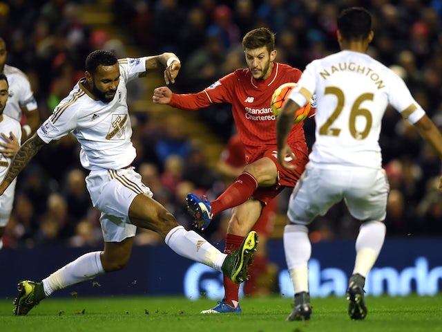 Swansea City's English defender Kyle Bartley vies with Liverpool's English midfielder Adam Lallana (2nd R) during the English Premier League football match between Liverpool and Swansea City at the Anfield stadium in Liverpool, north-west England on Novem