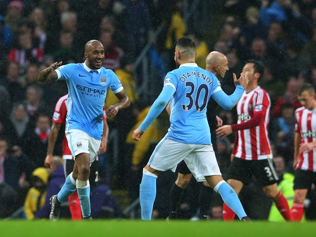 Fabian Delph (L) of Manchester City celebrates scoring his team's second goal with his team mate Nicolas Otamendi (R) during the Barclays Premier League match between Manchester City and Southampton at the Etihad Stadium on November 28, 2015