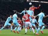 Manchester United's English defender Chris Smalling (3rd R) heads the ball during the UEFA Champions League Group B football match between Manchester United and PSV Eindhoven at the Old Trafford Stadium in Manchester, north west England on November 25, 20