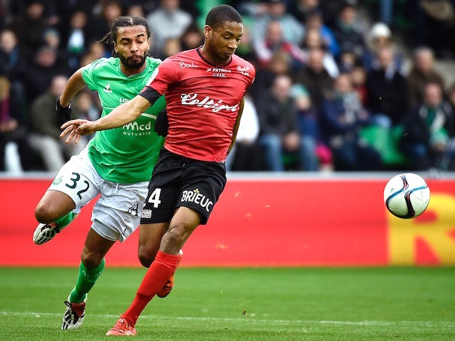Guingamp's French defender Marcus Coco (R) vies for the ball against Saint-Etienne's French defender Benoit Assou-Ekotto (L) during the French L1 football match AS Saint-Etienne (ASSE) vs Guingamp on November 29, 2015, at the Geoffroy Guichard Stadium in 