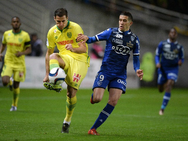 Nantes' Albanian defender Lorik Cana (L) challenges Bastia's French forward Florian Raspentino during the French L1 football match between Nantes and Bastia at the Beaujoire stadium in Nantes, western France, on November 28, 2015.