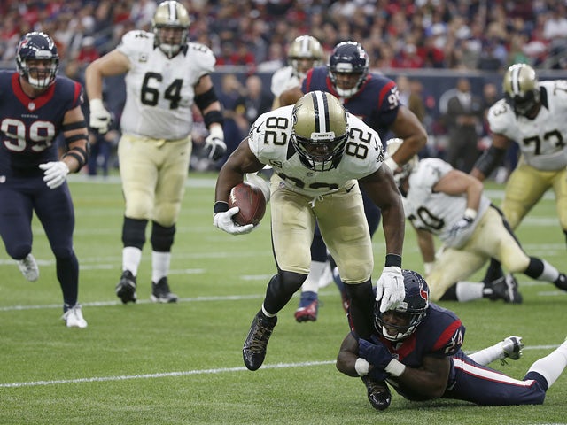 Benjamin Watson #82 of the New Orleans Saints is tackled by Johnathan Joseph #24 of the Houston Texans in the second quarter on November 29, 2015
