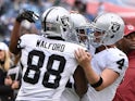 Clive Walford #88 and Derek Carr #4 of the Oakland Raiders congratulate teammate Michael Crabtree #15 on scoring a touchdown against the Tennessee Titans during the first half at Nissan Stadium on November 29, 2015