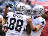 Clive Walford #88 and Derek Carr #4 of the Oakland Raiders congratulate teammate Michael Crabtree #15 on scoring a touchdown against the Tennessee Titans during the first half at Nissan Stadium on November 29, 2015