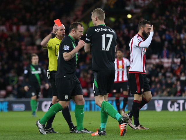 Ryan Shawcross (2nd R) of Stoke City is shown a red card by referee Mike Dean (1st L) during the Barclays Premier League match between Sunderland and Stoke City at Stadium of Light on November 28, 2015
